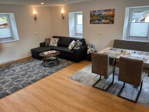a living room with a couch and a table at MyAlpenloft 2 in Deutschgriffen