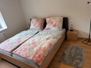 a bed with a comforter on it in a bedroom at MyAlpenloft 2 in Deutschgriffen