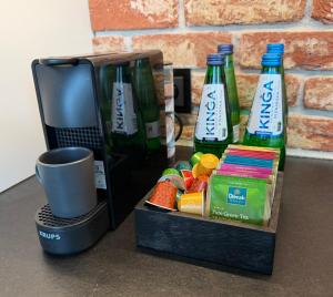 a table with two bottles of beer and a box of snacks at Studio Olesińska in Warsaw