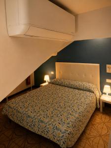 a bedroom with a bed with a large bedspread at Casa di Clara in Rapallo
