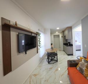 a living room with a flat screen tv on a wall at Apartamento Crisalidas em Foz in Foz do Iguaçu
