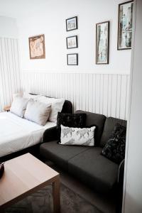 a living room with a couch and a bed at Nexus Apartman in Apatin