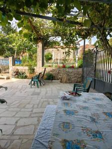 a patio with a table and chairs and a tree at Casa Nodar in Chantada