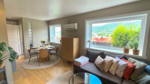 a living room with a couch and a table and a window at Cozy nest- walking distance to city center in Bergen