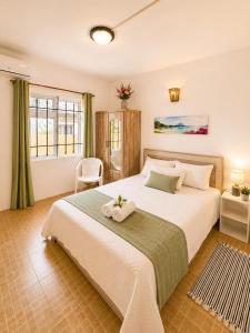 a bedroom with a large bed with towels on it at Pointe D'Esny Villa 1 in Mahébourg