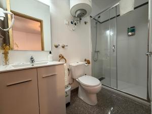 a bathroom with a toilet and a shower at El Bulín de Prádena - Calle Real in Prádena del Rincón +61 photos