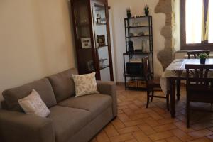 a living room with a couch and a table at Eva'house in Bolsena