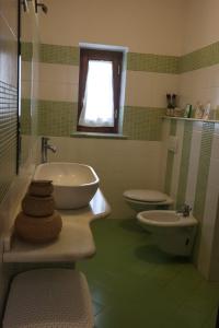 a bathroom with a sink and a toilet at Eva'house in Bolsena +9 photos