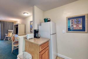 a kitchen with a refrigerator and a table with a microwave at Seafarer Resort-Unit 107 in Ogunquit