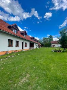 a courtyard of a building with a green lawn at Mlyn Vlachy 1997 in Vlachy