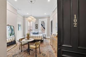 a living room with a table and chairs and a bed at The Concord Hotel in Boston +50 photos