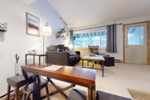 a living room with a table and a couch at SlopeSide Escape in Newry