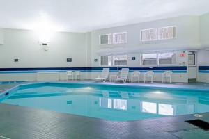 a large swimming pool with chairs in a building at SlopeSide Escape in Newry