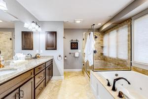 a bathroom with two sinks and a tub and a shower at At Ease On Long Sands in York Beach +47 photos
