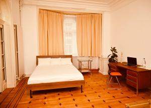 a bedroom with a bed and a desk and a computer at Viktoria B & B in Brussels