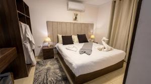 a bedroom with a large bed with white sheets at King Badr Pyramids Inn in Cairo