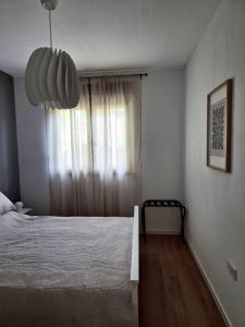 a bedroom with a bed and a window at Sutla House in Senkovec