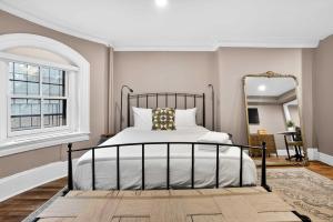 a bedroom with a bed and a large mirror at The Concord Hotel in Boston