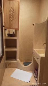 a small bathroom with a sink and a toilet at Riad Fadela in El Jadida +20 photos