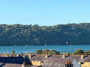 a view of a body of water with houses and trees at Spacious Central Flat with Parking in Bangor