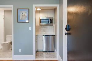 a kitchen with a refrigerator and a microwave at The Concord Hotel in Boston