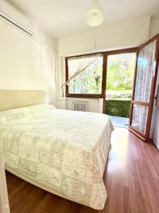 a bedroom with a bed and a large window at Blue Garden in Rapallo +31 photos