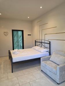 a bedroom with a bed and a couch at Helgis Center in Himare