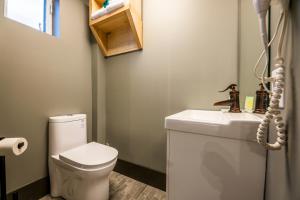 a bathroom with a toilet and a sink at La Suite Hotel in Shawinigan +17 photos