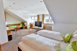 a bedroom with two beds and a living room at Hotel Hecht Garni in Ingolstadt +11 photos