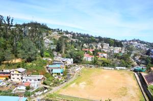 an aerial view of a town with a soccer field at hotel ruby international in Kodaikānāl