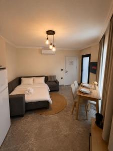 a living room with a bed and a table at Mirşah Suit in Dalaman