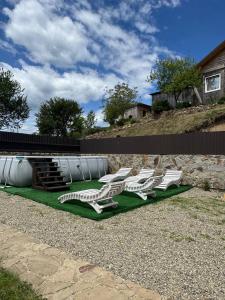 a group of white lounge chairs on a lawn at Hirska Vatra in Slavske