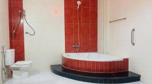 a bathroom with a bath tub and a toilet at King Badr Pyramids Inn in Cairo +61 photos