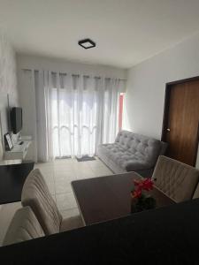 a living room with a couch and a table at Casa de praia in Marechal Deodoro