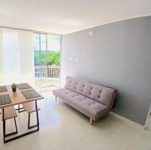 a living room with a couch and a table at Five Homes Ricaurte in Ricaurte