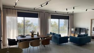 a living room with a dining room table and chairs at Carmelia Villas in Agios Nikitas