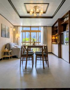 a dining room with a table and two chairs at Tiger House Kusabana in Akiruno