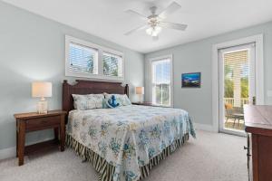 a bedroom with a bed and a ceiling fan at Elegant Beachfront Escape with Wrap-Around Porches in Pawleys Island