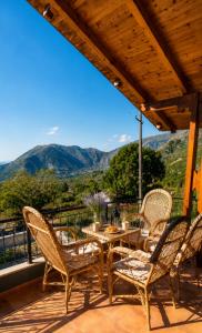 a patio with a table and chairs and mountains at Countryside Villa in Vlorë