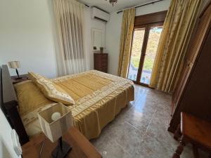 a bedroom with a bed and a large window at Casa Rural El Castillo in Málaga +25 photos