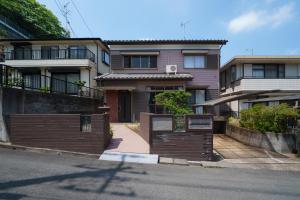 a house on the side of a street at Tiger House Kusabana in Akiruno