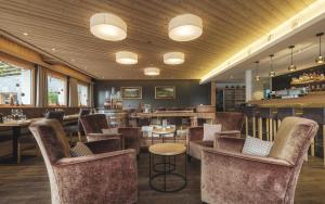 a restaurant with chairs and tables and a bar at Hotel Landhaus in Münster