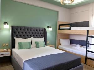 a bedroom with two beds and a bunk bed at Katerina's Resort in Sarti