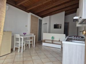 a kitchen with a table and chairs in a room at VILLA ANNAMARIA in Montesilvano