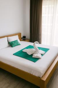 a bedroom with a bed with a swan on it at Alezzi Beach Resort Pool &Spa in Mamaia Sat/Năvodari +58 photos