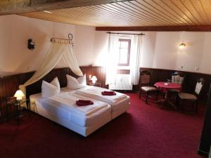 a bedroom with a large bed with a canopy at Holländer Mühle Rheinsberg in Rheinsberg +35 photos