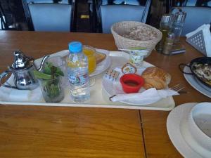 a tray with food and a bottle of water on a table at Taddart n Dades in Boumalne Dades