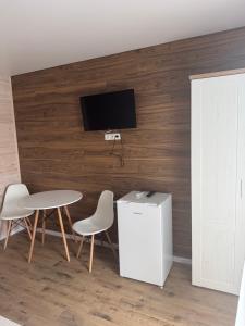 a room with a table and two chairs and a tv at LOTUS Hotel Solotvino in Solotvyno +122 photos
