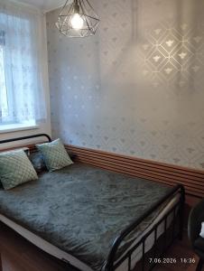 a bed in a room with a wall at Apartament Miodownik in Międzylesie