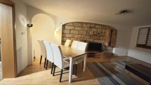 a dining room with a table and white chairs at Fewo Arthur am Elbtal in Meißen +32 photos
